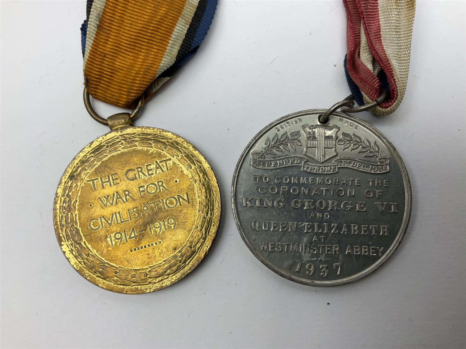 WW1 pair of medals awarded to 151761 Gnr. S. Loten R.A. with ribbons; four WW2 medals with ribbons; and small quantity of cap badges, medallions etc