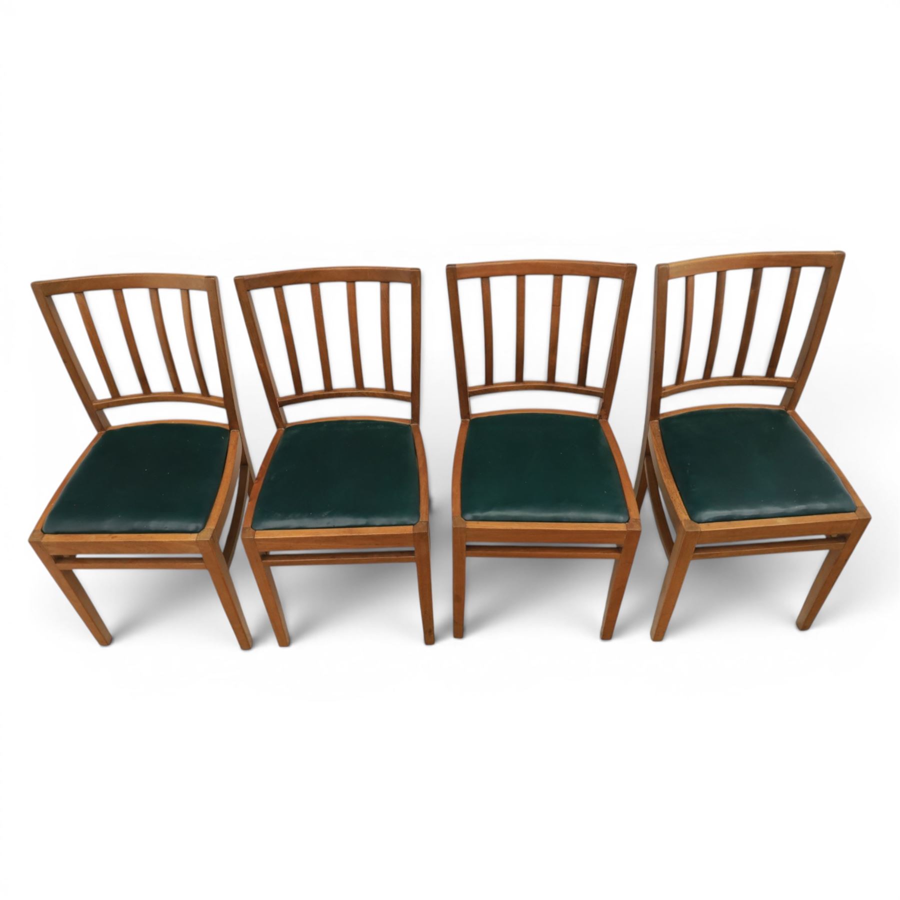 Mid 20th century teak extending dining table, together with eight teak chairs with green leather seats, extends to 154cm