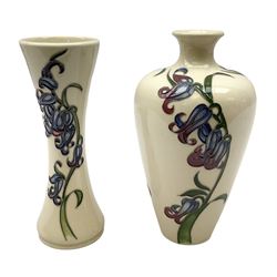 Two Moorcroft vases decorated in the Bluebell Harmony pattern by Kerry Goodwin, comprising a shouldered ovoid example and a slender waisted form example, both with impressed marks and stamps beneath, tallest H16cm