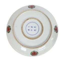 20th century Chinese charger, decorated in blue, green and red enamels with a four clawed dragon chasing the flaming pearl amidst waves and flower heads, the rim with border of alternating reserves of auspicious emblems and flower scrolls, bearing apocryphal Kangxi mark beneath, D38cm 

