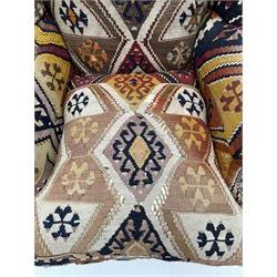 Late 20th century beech framed wingback armchair, sprung seat and back upholstered in kilim cover, acanthus carved cabriole supports with ball and claw feet