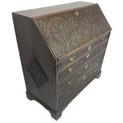 18th century heavily carved oak bureau, the fall front relief carved with three arches enclosing plants and flower head decoration, the interior fitted with pigeonholes, drawers and cupboard, four graduating cock-beaded drawers below, carved with lunettes and trailing foliage decoration, on bracket feet