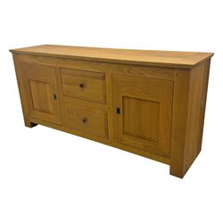 Contemporary light oak sideboard, chamfered rectangular top over two central bevel-edged drawers, flanked by two recessed panelled cupboards enclosing shelving, on square stile supports