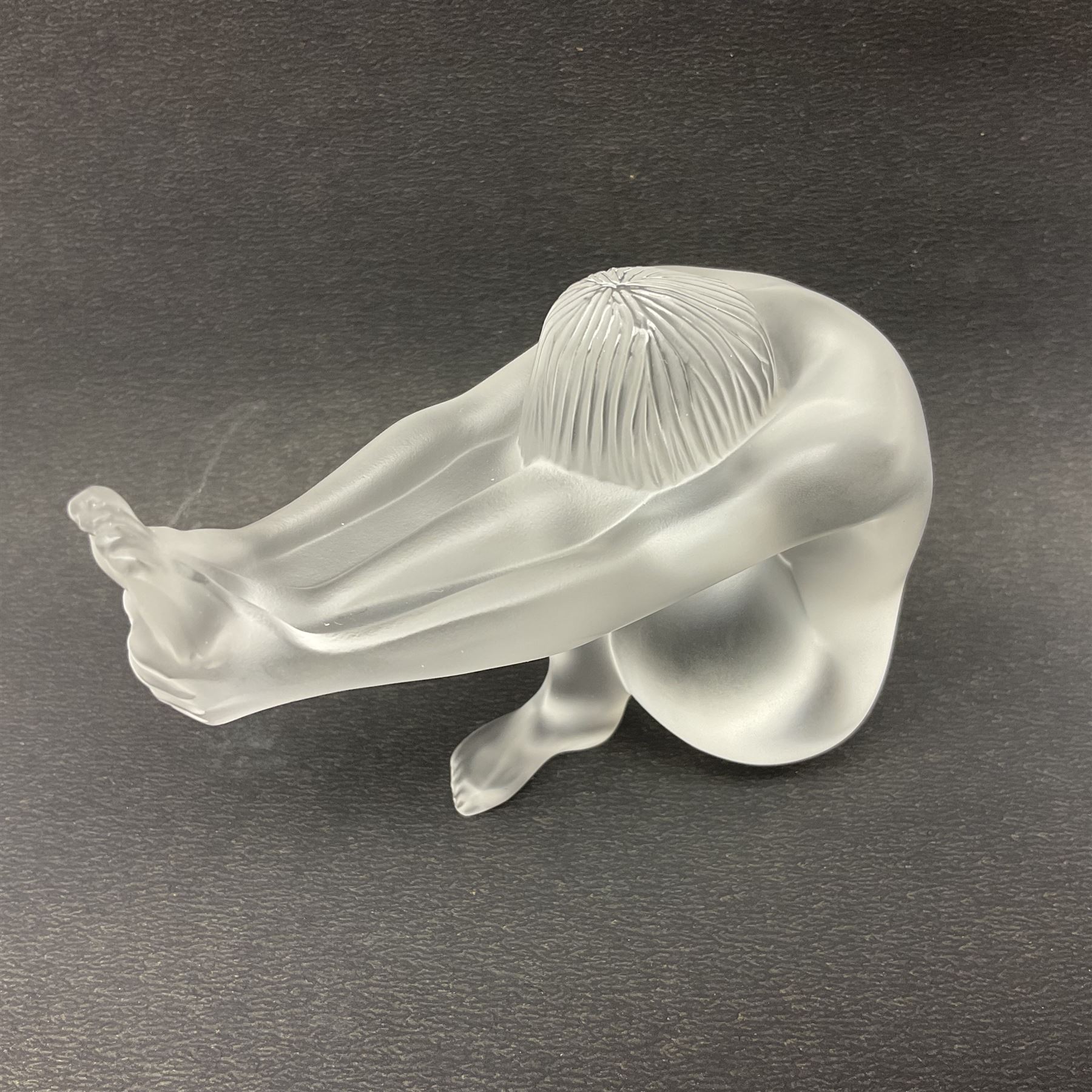 Lalique Nude Temptation, a frosted glass figure of a woman crouching with leg outstretched, in original box, H8cm
