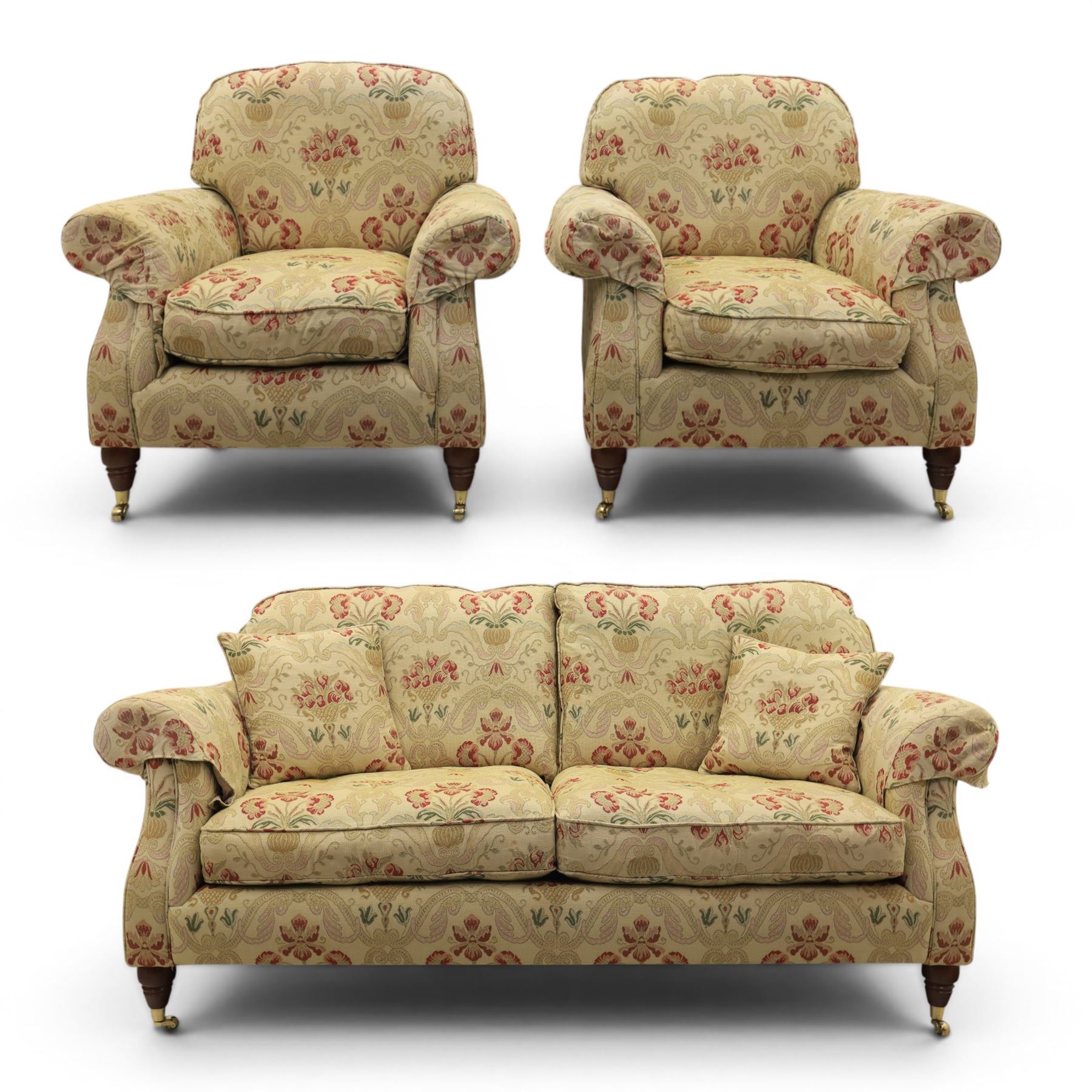 Parker Knoll - 'Henley' floral fabric living room suite, comprising a two seat sofa and pair of armchairs, raised on dark stained turned feet raised on brass castors

Armchairs (H 99cm, W 95cm, D 100cm)