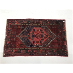 Afghan hand knotted red ground rug, diamond centre with geometric pattern, 195cm x 122cm