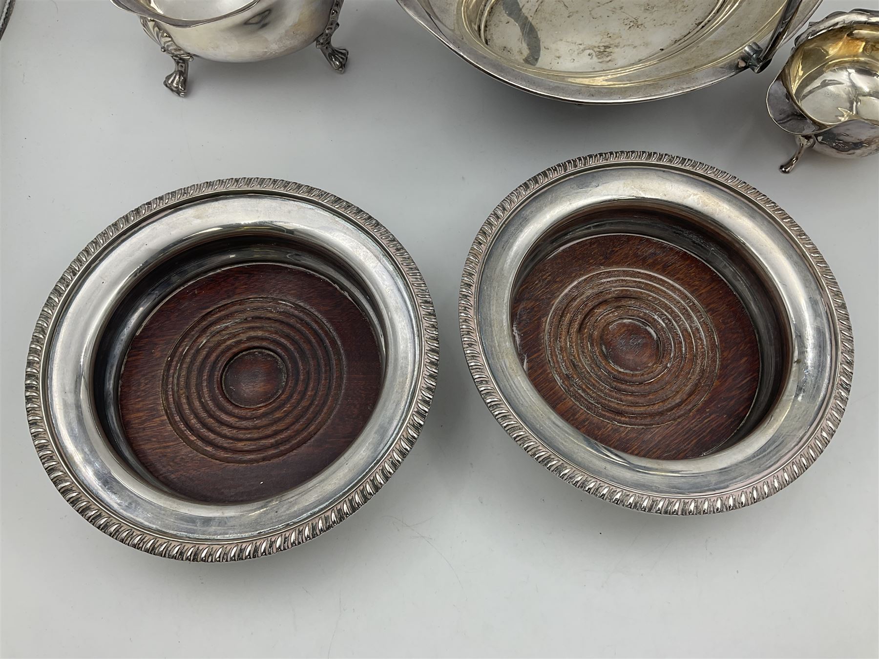 Silver plated seven bar toast rack by Mappin & Webb, together with other silver plated items including pair of bottle coasters, swing handled baskets and two sauce boats