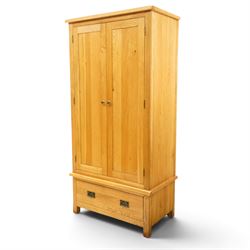 Contemporary light oak double wardrobe, fitted with two panelled cupboards over single drawer