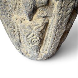 Cast stone Romanesque design urn of tapering form, decorated in relief with motifs of zoomorphic figures and swans within foliate and guilloche cast architectural arches with Neoclassical columns, in weathered finish