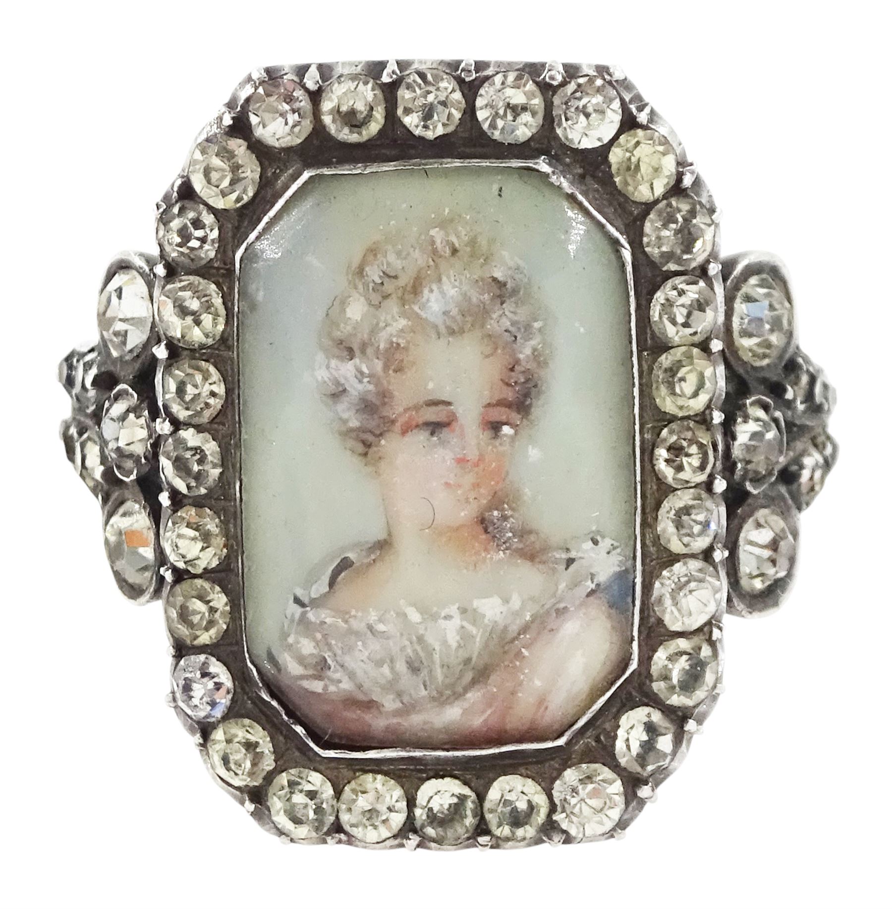 19th century 18ct gold and silver paste set portrait ring, octagonal miniature of a woman on ivory, under a glazed panel, with paste stone surround, to bifurcated paste set shoulders. This lot has been registered for sale under Section 10 of the APHA Ivory Act