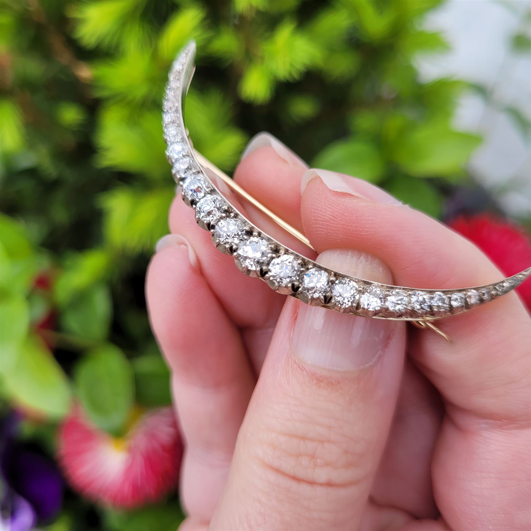 19th century silver and gold diamond crescent moon brooch, set with twenty-one graduating old cut diamonds and six rose cut diamonds, total diamond weight approx 2.00 carat