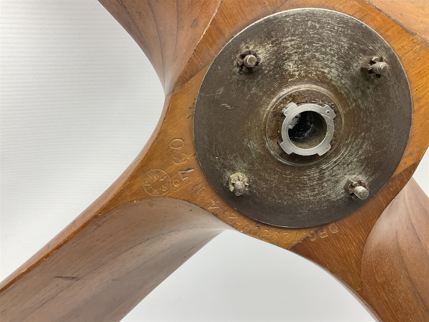 British World War II era laminated wooden four-bladed generator propeller, late 1930s-40s, used to power a drogue winch used by a target tug aircraft; marked with DRG drawing number T29505-2-4 N760 on the hub and impressed circle mark 'P.M.P.W. 1'; light weight four plank mahogany laminate with 9.5cm diameter metal plates mounted to front and rear faces of hub for 15mm shaft; one plate marked T29504-2/198 D91cm; together with a modern reproduction brass edged mahogany two-blade propellor L