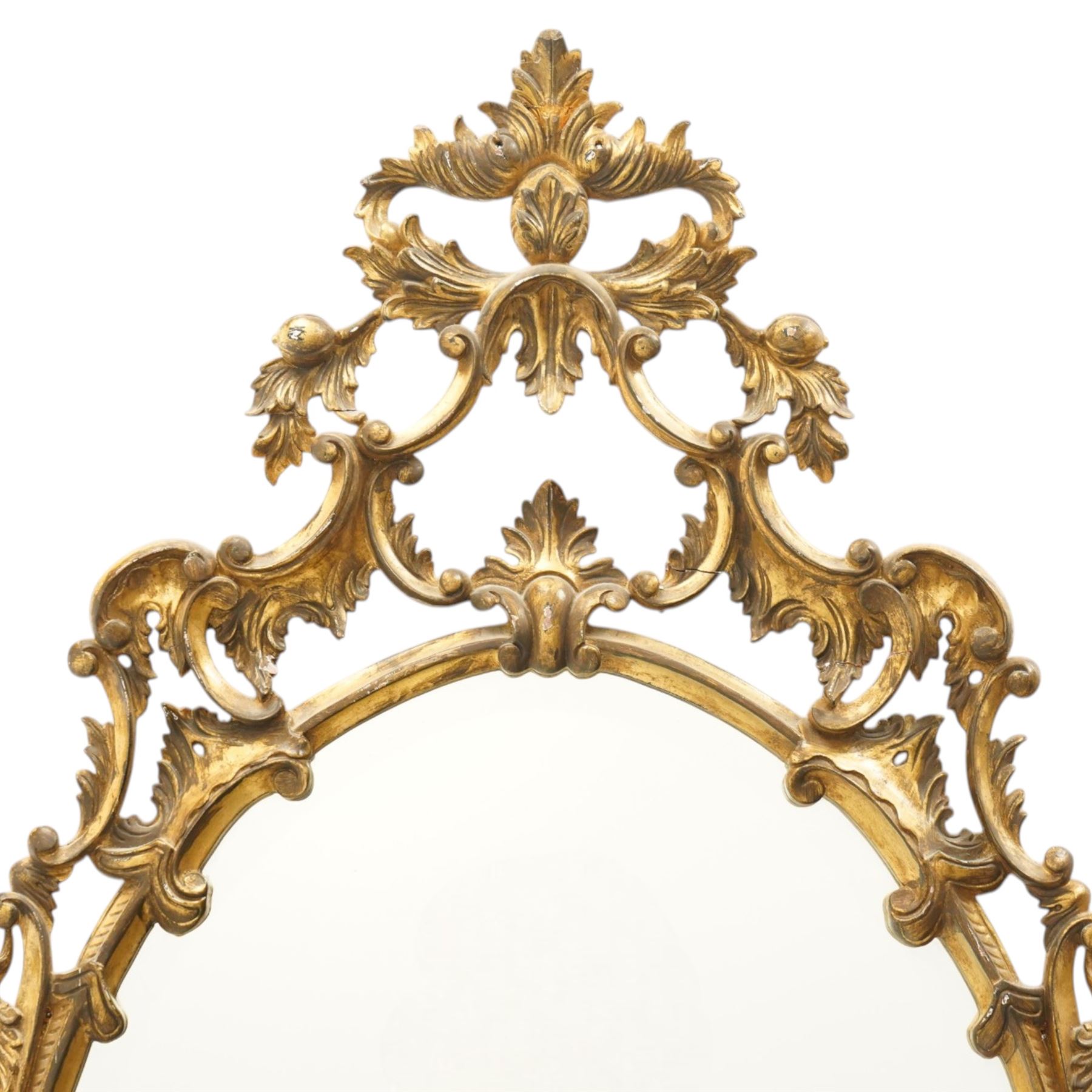 Rococo design giltwood and gesso wall mirror, oval plate within moulded frame, pierced cresting and apron, decorated with acanthus leaves, flowerheads and trailing foliage