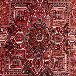 North West Persian Heriz hand-knotted carpet, brick red field, with large central angular star medallion with stepped outlines, surrounded by geometric floral devices and stylized rosettes, with corresponding corner spandrels, enclosed by a bold geometric main border with multiple guard stripes, with cotton fringe ends 