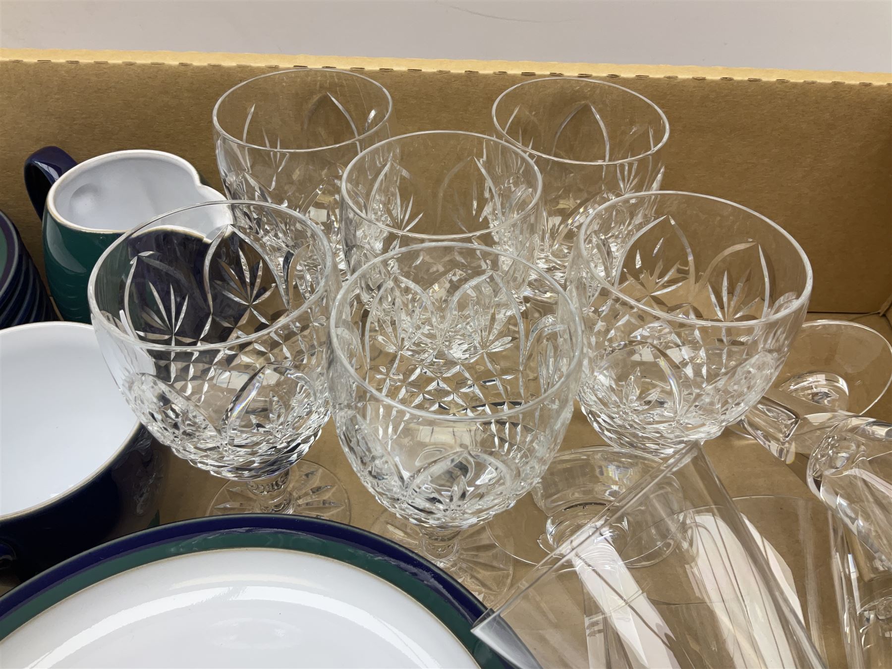 set of six Dartington champagne glasses, with an internal elongated tear in the stem, together with a set of six wine glasses and Denby regatta pattern tea wares comprising of milk jug, eight dessert plates, nine tea cups and eight saucers 