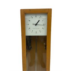 A mid-20th century Gent of Leicester(Blick Electric) Pulsynetic Master Clock in a full length glazed wooden case, with a square white dial with Arabic numerals, minute markers and baton hands, with pendulum and a record card dating from the 1970’s. 
This master clock would have been wired to send time signals to other slave dials in a large building, frequently used in hospitals, schools and factories during the 20th century
With a second electrical movement housed in a glazed square cabinet.


