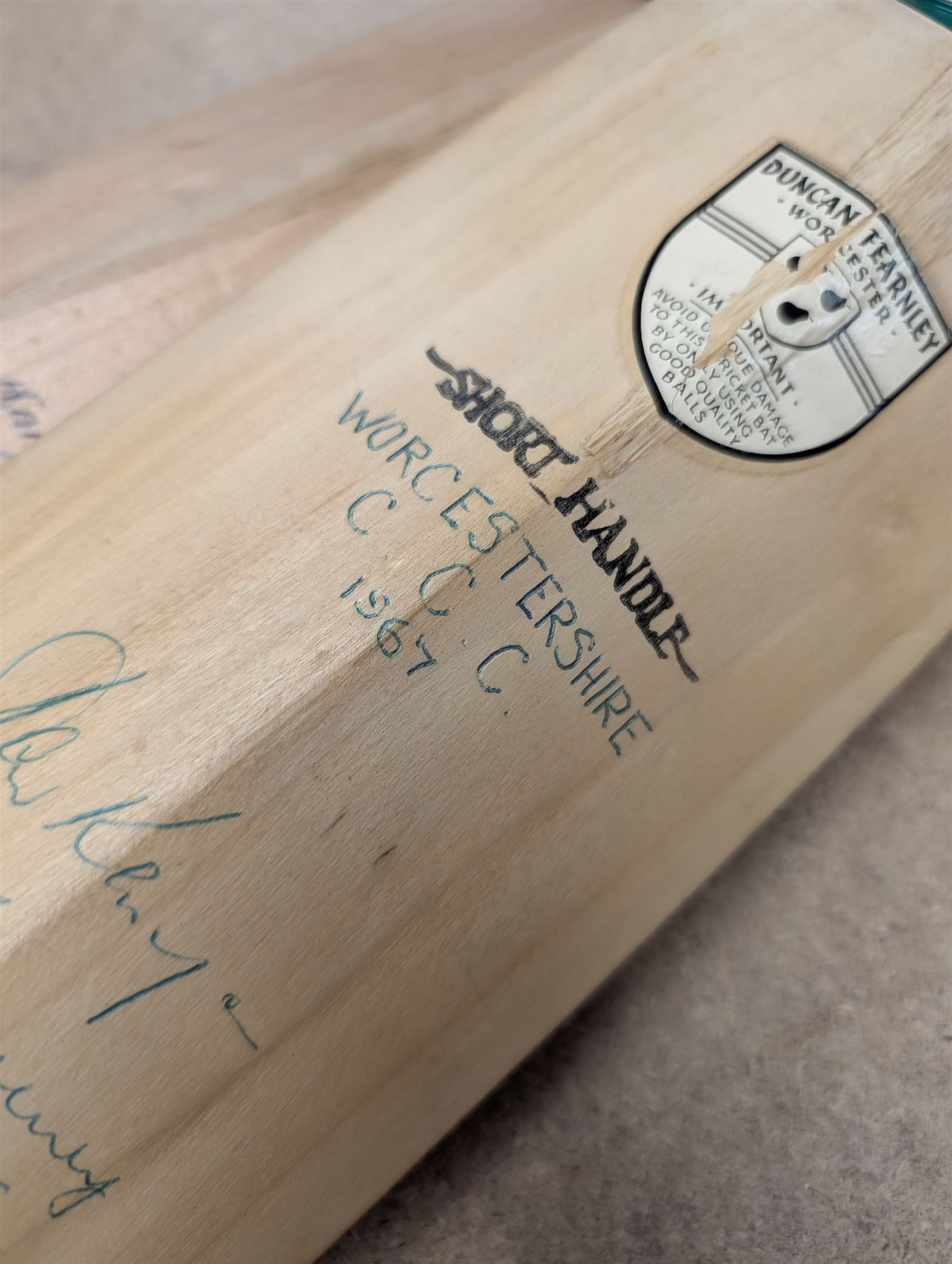Two signed cricket bats, with signatures including Colin Cowdrey