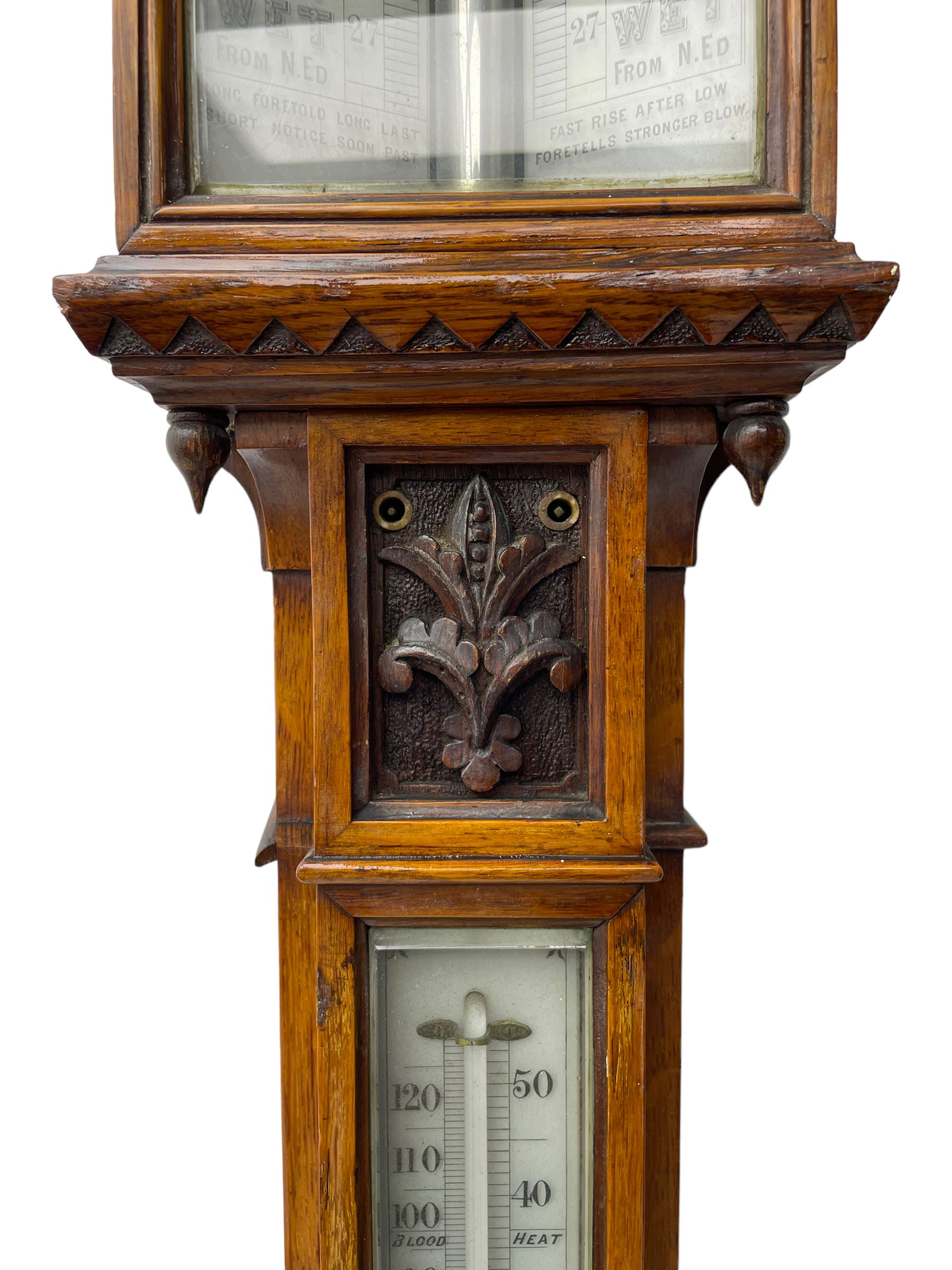 J Hicks - Hatton Garden London, - late 19th century carved oak cased Fitzroy barometer in a richly carved case with a carved crested pediment and square cistern cover, inverted opaline register reflecting FitzRoy's predictions and a scale from 27 to 31 inches of barometric pressure, with a thick bore cistern tube and adjustable rack and pinion twin vernier, fitted with a glazed snail bulb mercury thermometer recording the air temperature in both Fahrenheit and Celsius. Mercury clean and present.
James Joseph Hicks was born in Ireland, however, early in his life he moved to London where he was apprenticed to the instrument maker Louis P Casella. In 1860 he went into business in his own right as a scientific instrument maker at 8 Hatton Gardens. In 1864 he was granted membership to the British Meteorological Society and exhibited instruments at the Royal Society Exhibitions between 1876 and 1913. Hicks was one of London's most prolific and eminent barometer makers. 