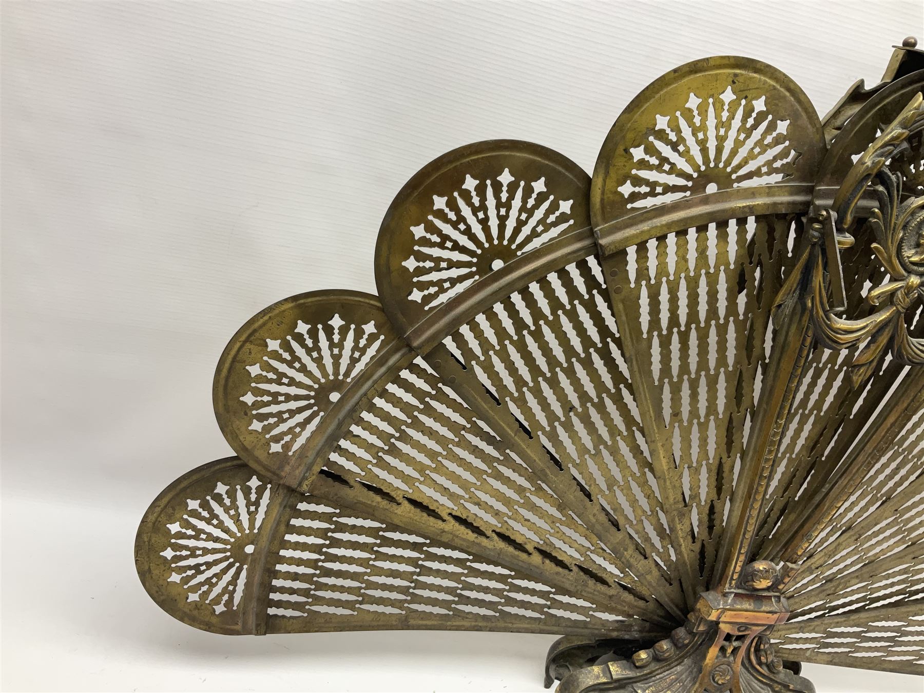 Pierced brass peacock style folding fire screen, with urn finial, H65.5cm