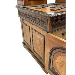 19th century Anglo-Indian teak/camphor twin pedestal desk, raised back fitted with pierced and foliate carved panelled sliding doors, enclosing pigeonholes and correspondence drawers, rectangular top with ebonised banding and moulded edge over a lunette carved frieze, fitted with nine drawers, decorated with carved and pierced mounts