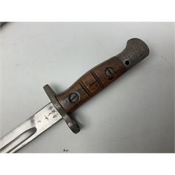 WW1 British 1907 pattern bayonet, the 43cm single edged fullered blade stamped to the ricasso with a crown GR cypher 1907 8 15 Sanderson, with various ordnance marks verso, two piece walnut grip, pommel stamped 1HLI 354; in steel mounted leather scabbard stamped 140 to the throat L57cm overall