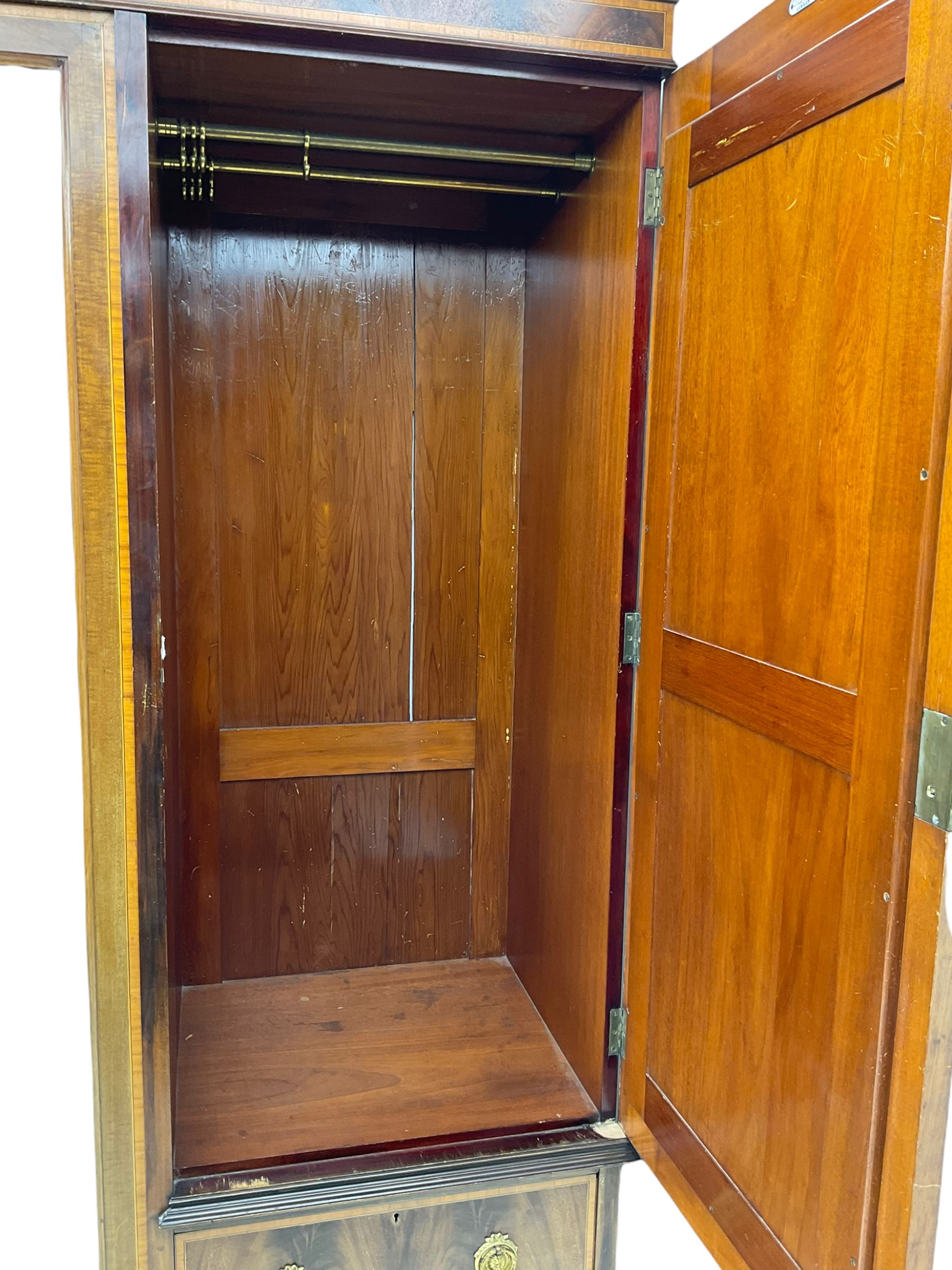 James Shoolbred & Co. London - Edwardian inlaid mahogany triple combination wardrobe, projecting dentil cornice over bevel glazed door, two figured oval panelled doors and four drawers, the central compartment fitted with linen slides and drawers, satinwood banding, on base with shaped apron and bracket feet, with enamel plaque 
