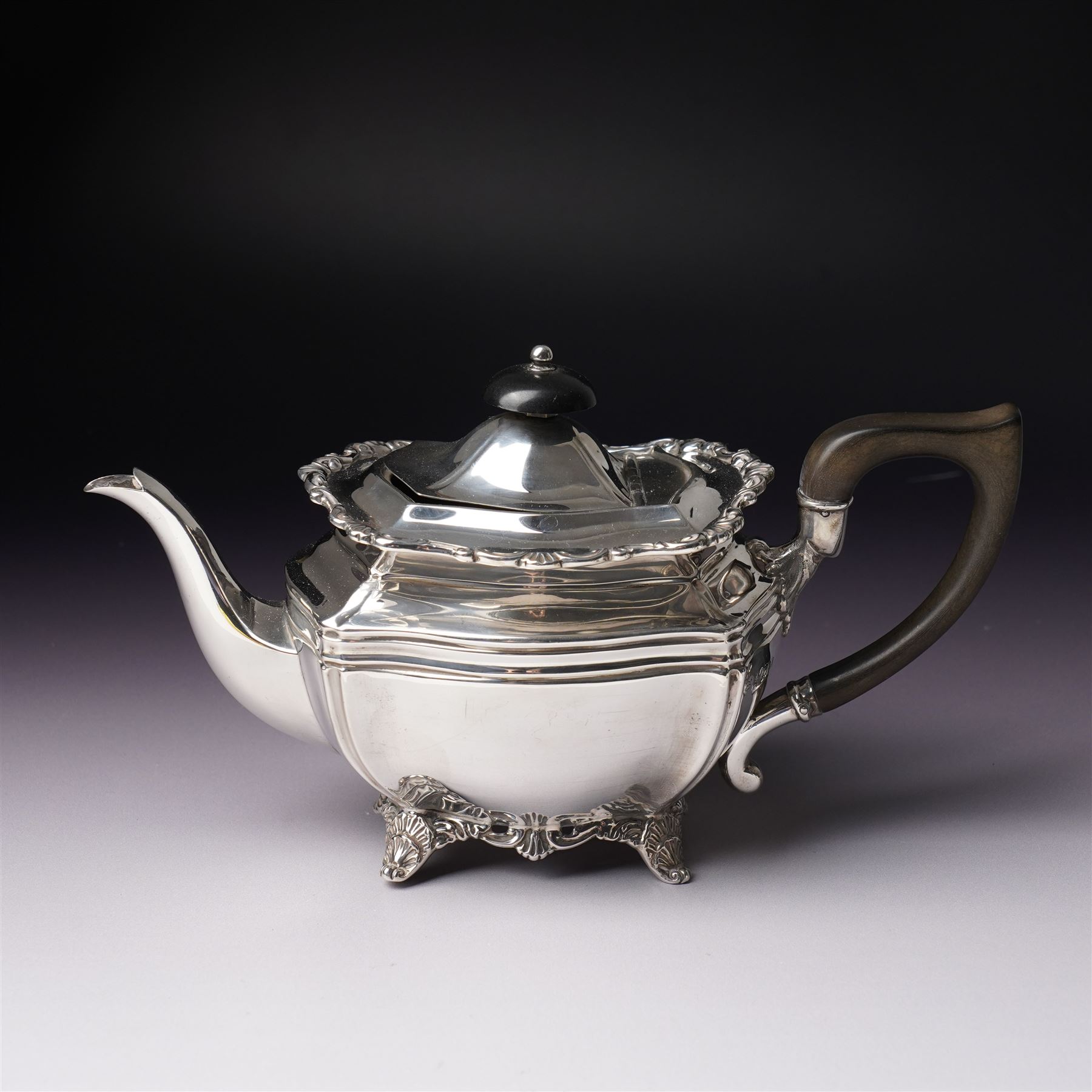 Edwardian silver three piece bachelors tea set of panel sided rectangular form with shell and scroll borders on shell moulded feet London 1903- 1905 Maker Josiah Williams & Co