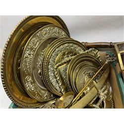 Quantity of copper pans and teapots, dish and sieve with pierced heart decoration and brass handle, together with quantity of brassware to include brass Art Nouveau crumb tray and brush, repousse chargers, fire tool accessories, decorative canon, sword and guns etc