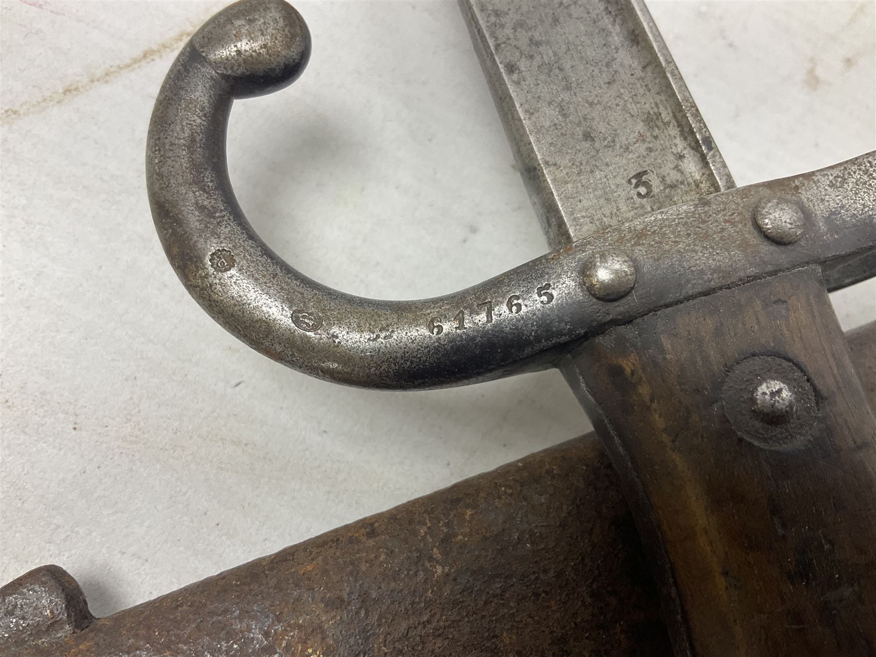 French Model 1874 Epee bayonet marked Oulle 1876 in associated scabbard; Model 1866 sabre bayonet in cut-down sword scabbard; and Model 1842/59 sabre bayonet in relic condition (3)