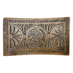 Late 19th century oak stool, rectangular dished top relief carved with floral lunettes and central insignia, on turned splayed supports