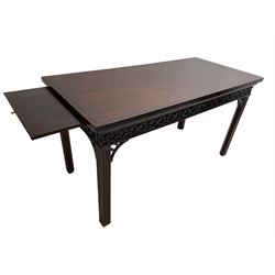 In the manner of Thomas Chippendale - early 19th century mahogany serving table, rectangular crossbanded top with boxwood stringing, the frieze with upper moulding over applied geometric fretwork, the left-hand side fitted with slide, on fluted square supports with inner chamfer 