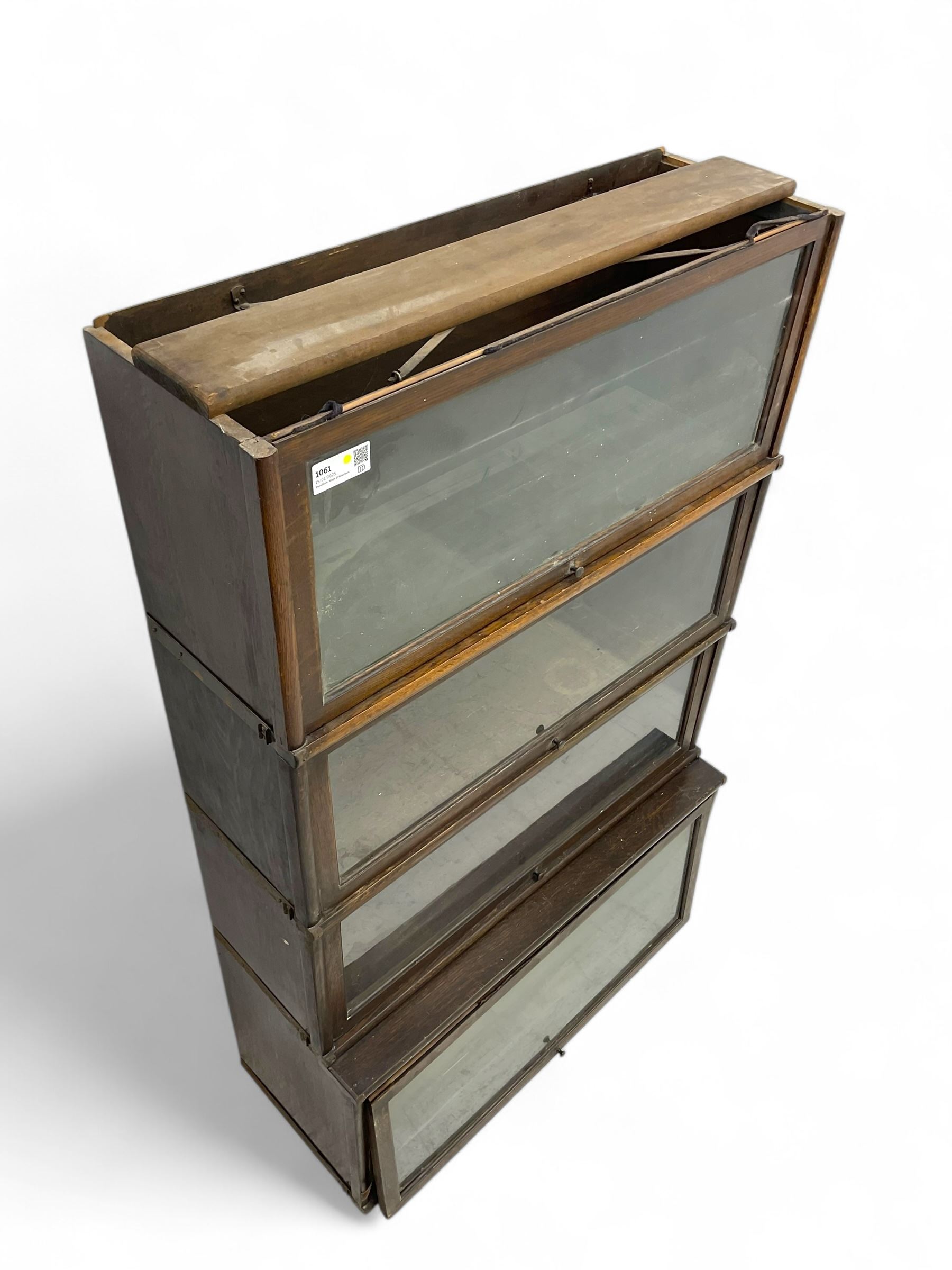 Globe Wernicke - early 20th century oak four-tier stacking library bookcase, four glazed sections enclosed by hinged and sliding doors