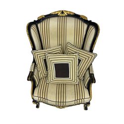 Thomas Messel - Georgian style ebonised and gilt wingback armchair, upholstered in striped fabric, on cabriole front feet