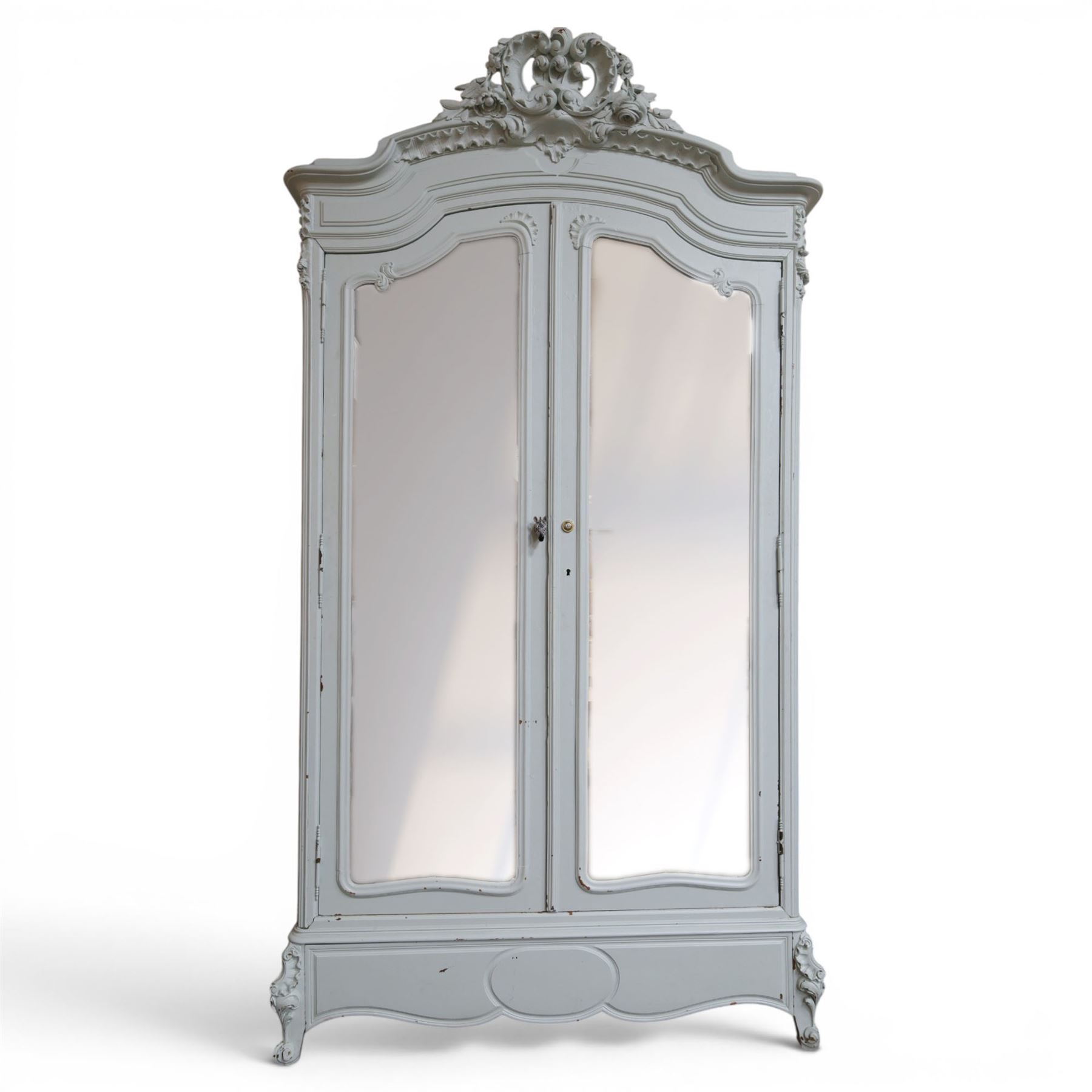 French Louis XV style pale blue painted armoire, with carved floral and foliate crest over a shaped moulded cornice, fitted with two bevelled mirror panel doors enclosing hanging space and drawer, above shaped apron, raised on carved cabriole supports