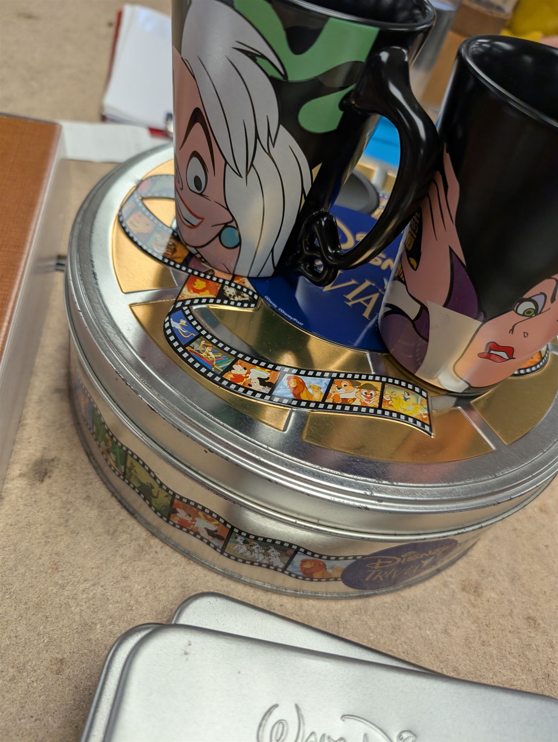 Collection of Disney memorabilia and ephemera, including Walt Disney Treasures DVD, two Disney Villains mugs, enamel pins, Mickey Mouse D23 fan club pack, Disney Twenty-Three magazines, Sketches magazines, etc