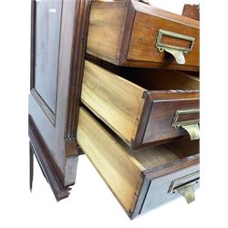 The Shannon Limited - late Victorian walnut filing cabinet, fitted with twenty-four small filing drawers, each with brass handle with label holder, fluted uprights, double cupboard below enclosed by two panelled doors, on turned feet, with brass plaque inscribed 'The Shannon, Limited, Ropemaker St. London, E.C.'