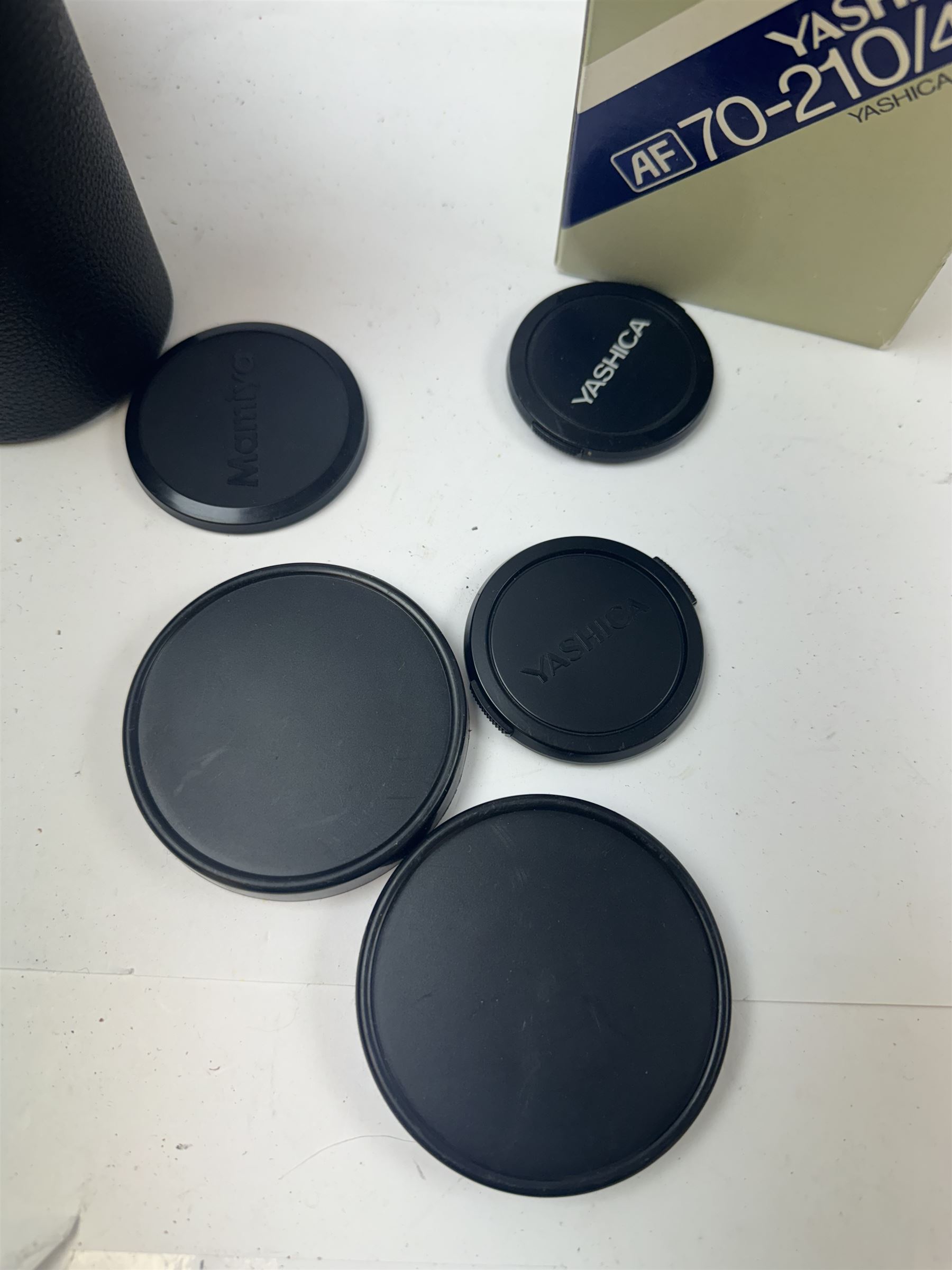 Group of camera lenses, comprising Yashica AF 70-210mm 1:4.5 58mm lens serial no. F6106983, boxed, Yashica AF 35-70mm 1:3.3-4.5 52mm Macro lens serial no. F60231147, Yashikor Aux Wide Angle 1:4 lens and a Yashikor Aux Tele-Photo 1:4 lens, Mamiya-Sekor E 1:2.8 f=28mm serial no. 13427 and a Mamiya-Sekor Zoom E 1:4 f=80-200mm lens serial no. 11271