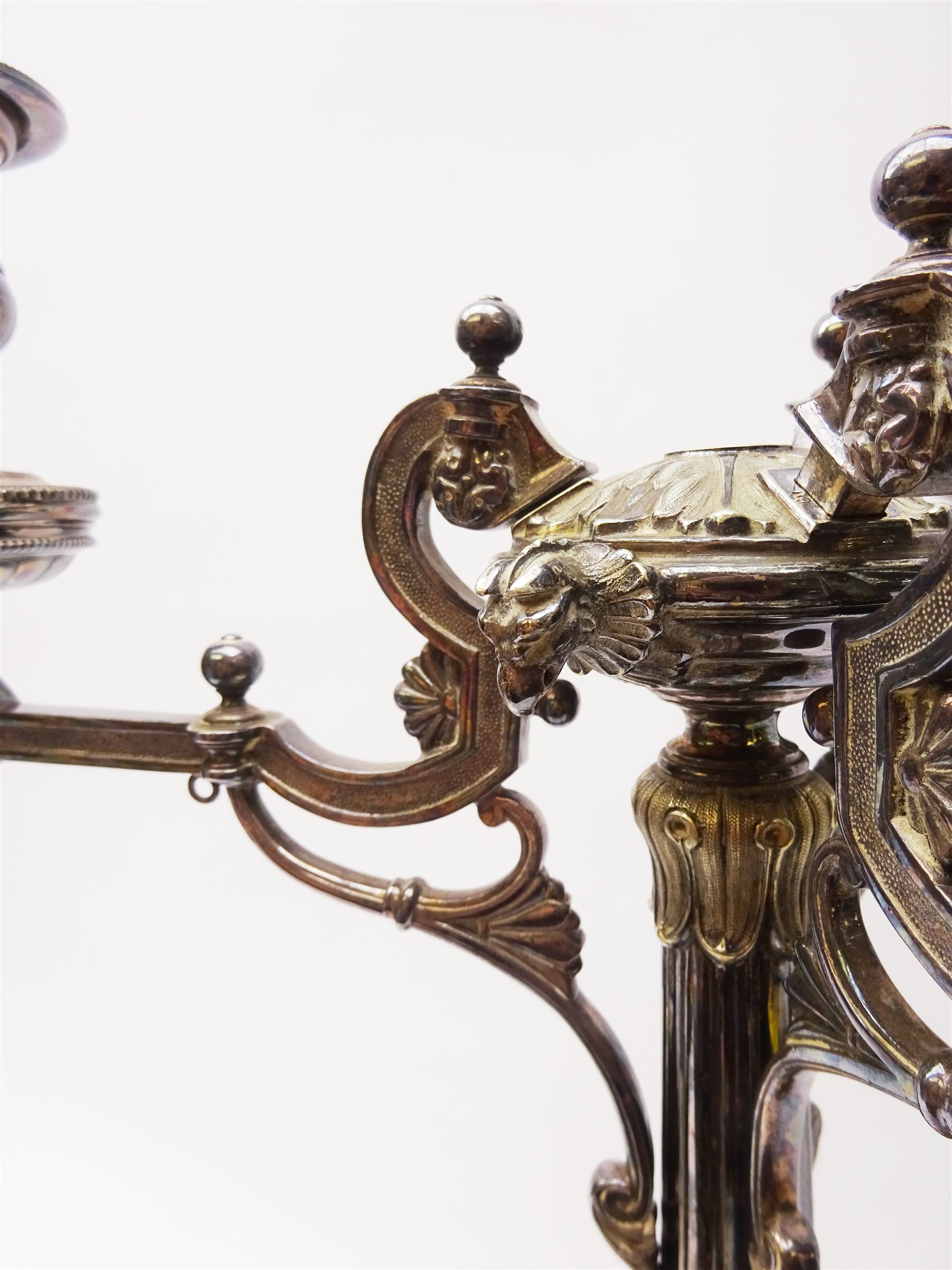 A large Victorian Thomas Bradbury & Sons silver plated candelabrum, the circular base with flower head border upon three domed feet, supporting a central knopped and fluted column flanked by three zoomorphic creatures, leading to a central socket with removable nozzle above a large palmette detailed drip pan, and three scrolling branches with conforming sockets and nozzles, with maker's silver plate mark and Victorian registration lozenge beneath, H62.5cm