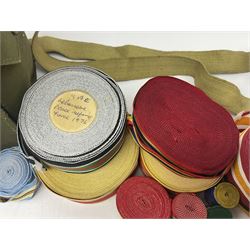 Quantity of modern medal ribbons in various length rolls and strips; and WW2 gas mask case dated 1943