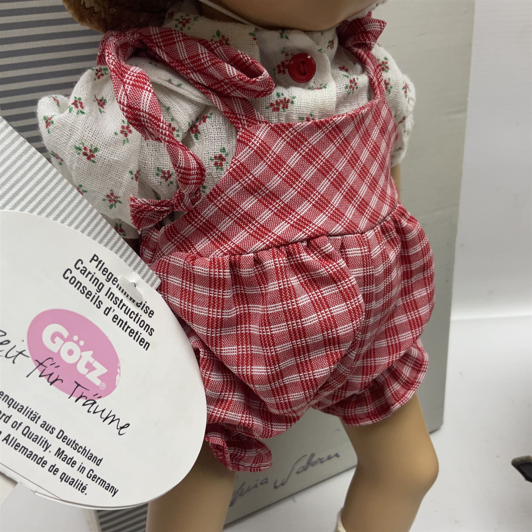 German Gotz articulated vinyl baby doll 'Claire' c1997 with original clothing, hat and labels; artist designed by Sylvia Natterer H35cm; boxed; and small child's wooden cased drum (2)