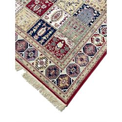 Bakhtiari design rug, the field divided into panels each decorated with tree of life and floral motifs, the main border decorated with Hac motifs 