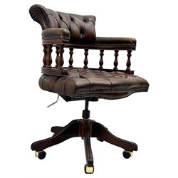 Mahogany framed swivel Captains desk chair, upholstered in brown buttoned leather, turned supports and swivel base on castors