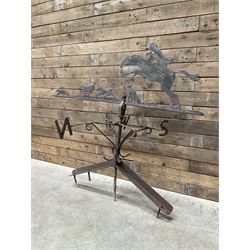 Black painted wrought iron weather-vane depicting hunting scene and compass points