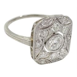 Platinum Art Deco style diamond panel ring, the rectangular curved pierced panel with a central round brilliant cut diamond of approx 0.25 carat and diamond surround, stamped Plat, total diamond weight approx 0.50 carat