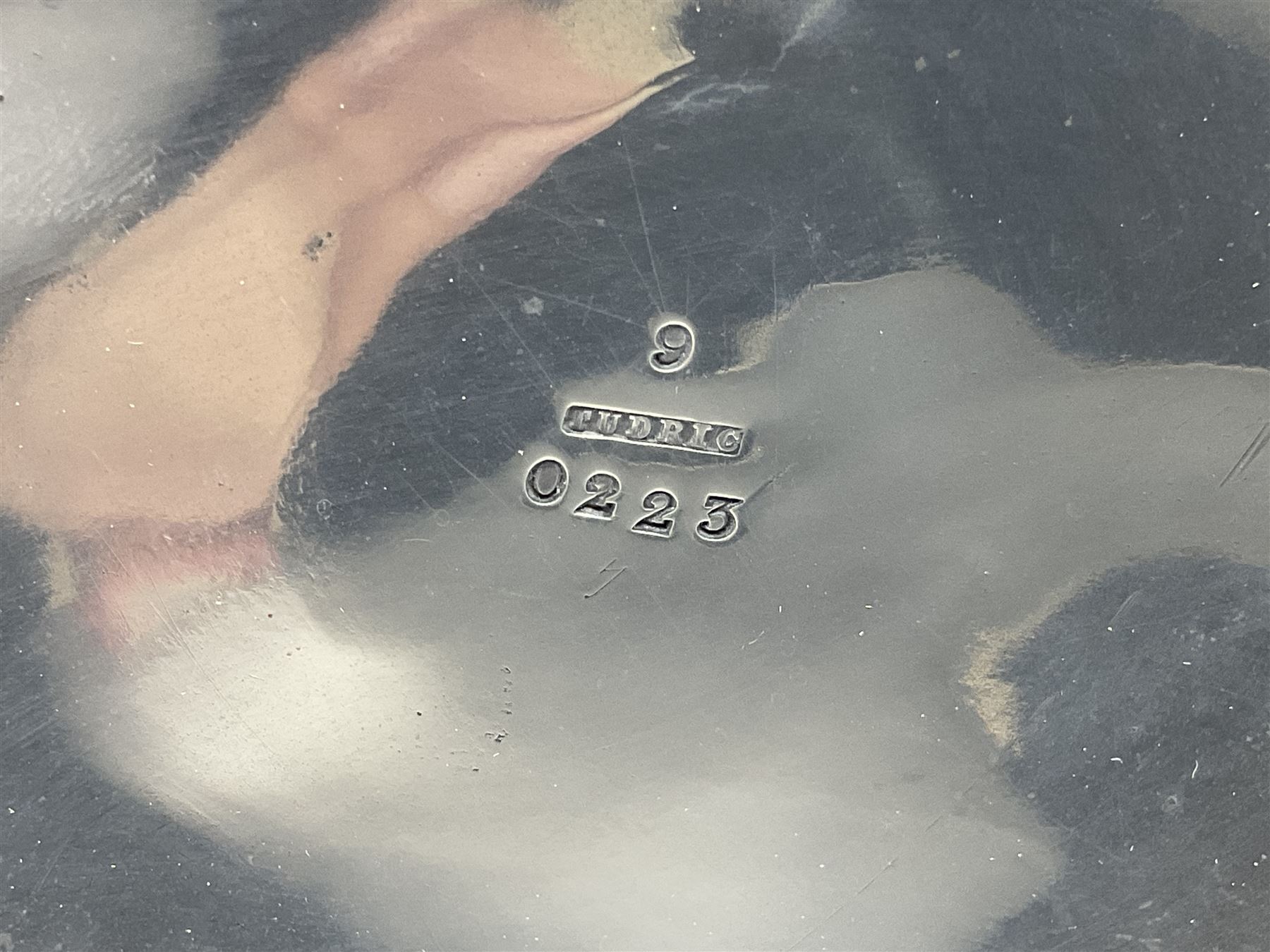 Archibald Knox (1864-1933) for Liberty & Co, pair of Tudric pewter candlesticks, the bud shaped sockets raised upon three angular fin supports and a slightly domed circular base with cast stylised foliate decoration, each stamped beneath Tudric 0223, H30cm