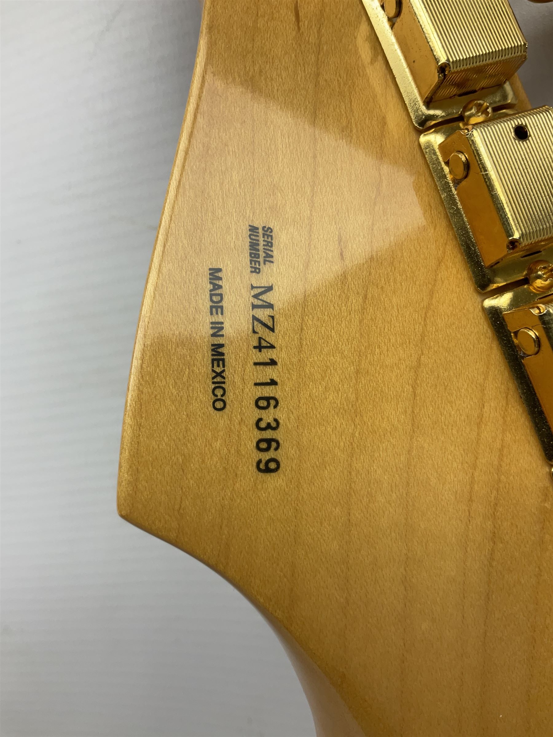 Fender Stratocaster 50th Anniversary 2004 metallic gold electric guitar; serial no.MZ4116369; L98cm; in Spider fitted case with owners manual and other paperwork, strap and belt buckle etc