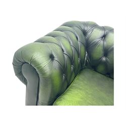 Two seat Chesterfield design sofa bed, upholstered in emerald green leather with deep-buttoned detailing, rolled arms, two loose seat cushions, and pull-out 