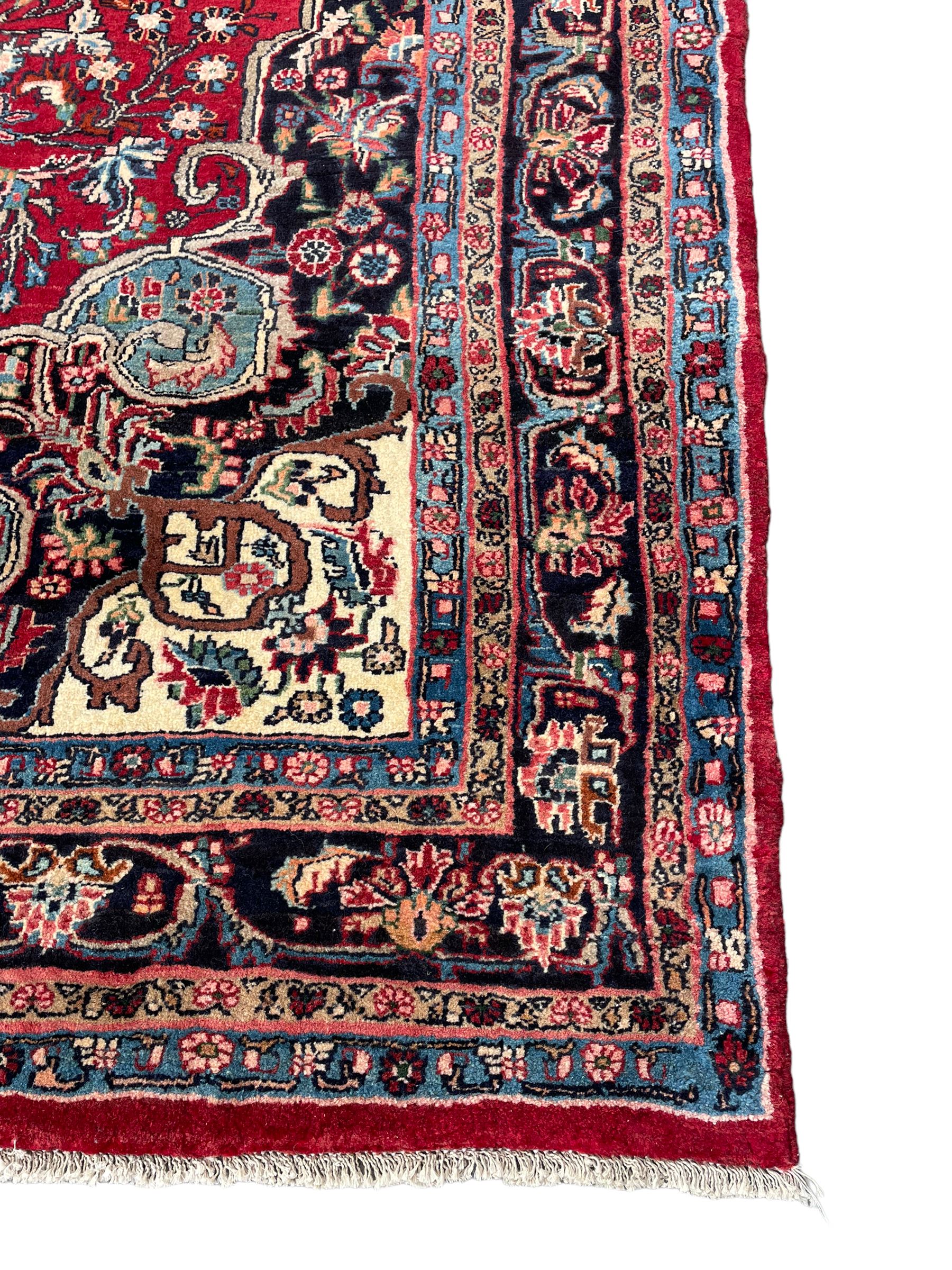 North West Persian Bidjar red ground carpet, shaped pole medallion surrounded by interlacing branches and stylised flower heads, five band border with repeating floral design