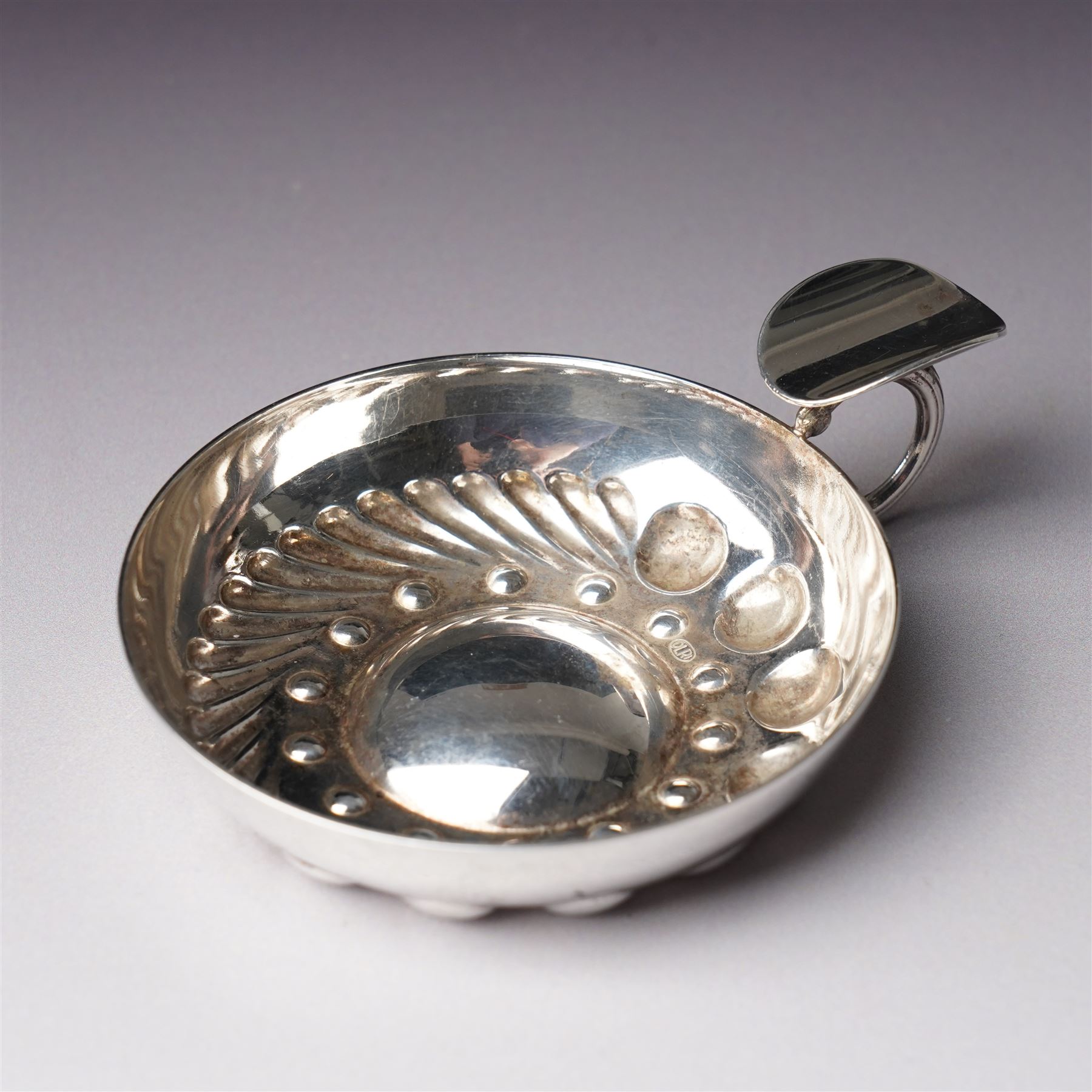 French silver tasse de vin with Minerva's head and makers mark J.P. with an anchor, the rim engraved C Mouly, Spanish tasse de vin inset with a silver coin and two other tasse de vin (4)