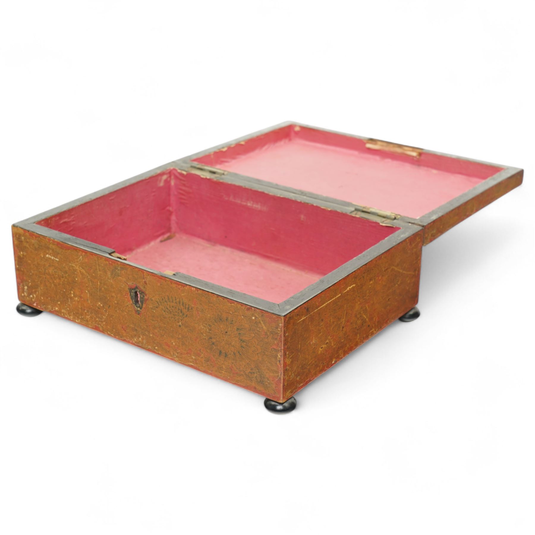 Regency red lacquered penwork box, of rectangular form on bun feet, decorated with classical figures in a landscape among foliate motifs, W28cm 